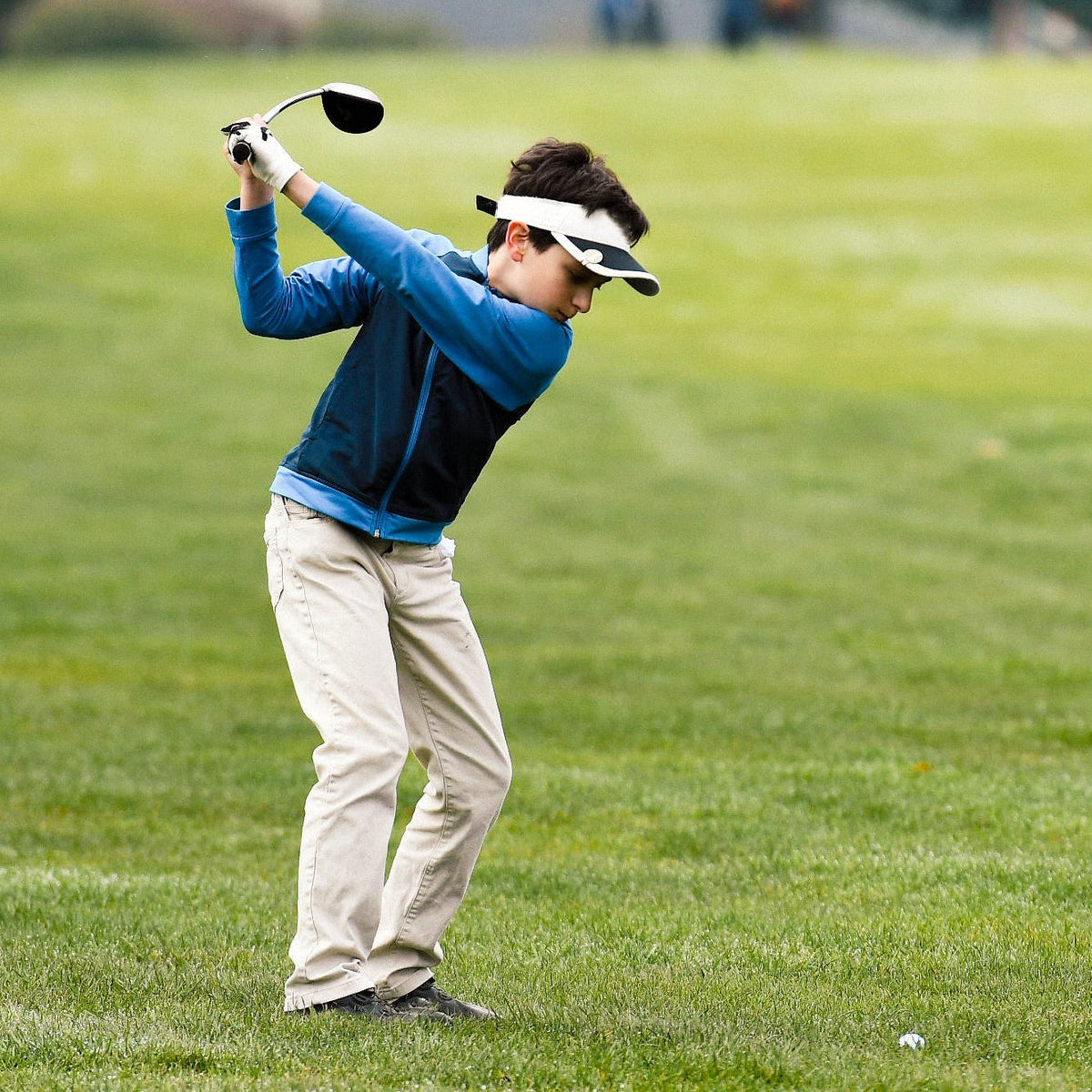 Junior golfer training with SuperSpeed speed sticks